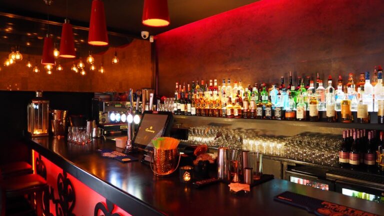 Home Enjoy the warm ambiance of a well-stocked, illuminated bar perfect for nightlife and celebrations.